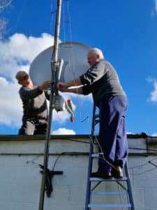 Chris and John attaching a QO-100 dish to a pole